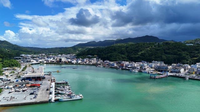 Coastal city with mountains and harbor