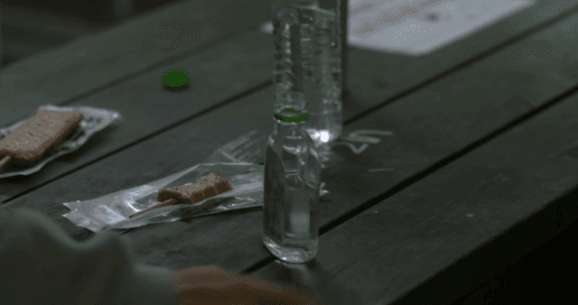 Person putting down soju on table