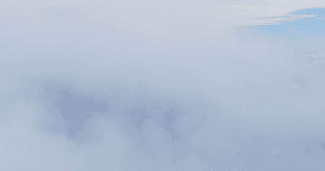 Village landscape partially obscured by clouds