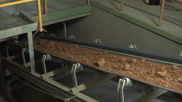 Conveyor belt transporting soil