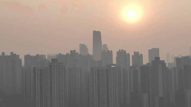 Skyscrapers at sunrise with a hazy sky