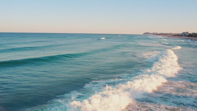 Waves gently rolling onto a sandy beach