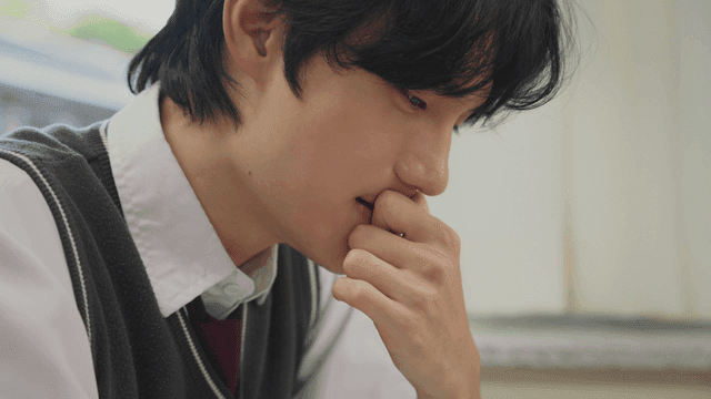 Student deep in thought at a desk