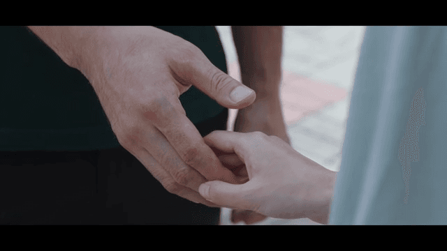 Two people holding hands outdoors