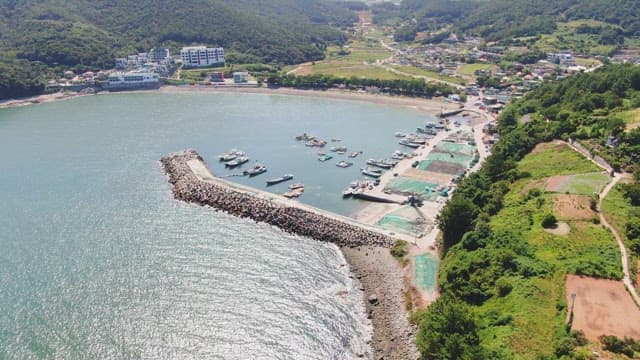 Coastal village with boats and mountains