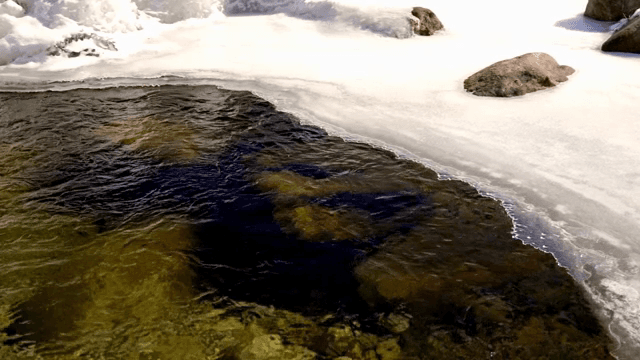 Flowing river with ice and rocks