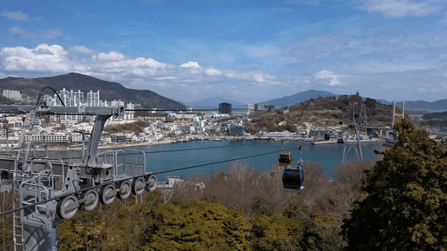 Cable cars over a scenic coastal city