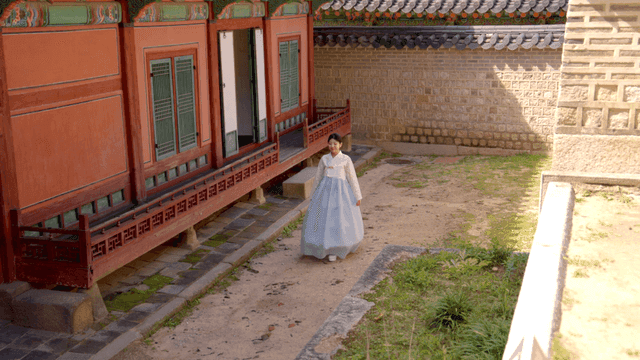 Traditional Korean house with a woman in hanbok