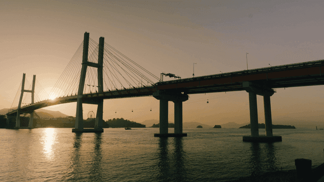Bridge over calm water at sunset