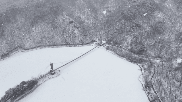 Snow-covered mountains and a bridge