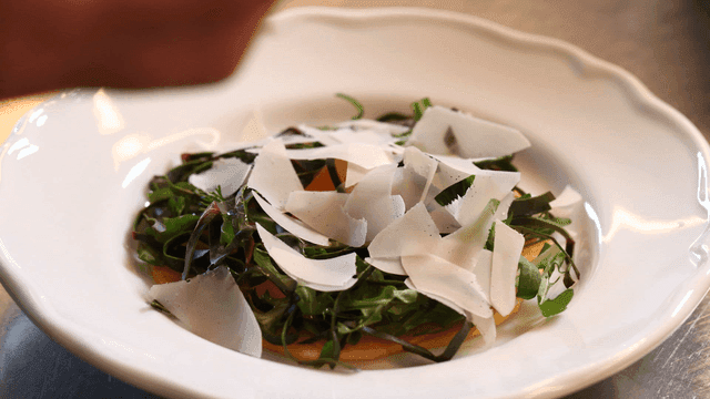 Fresh salad with cheese shavings