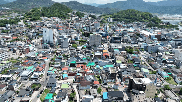 Wide cityscape surrounded by hills