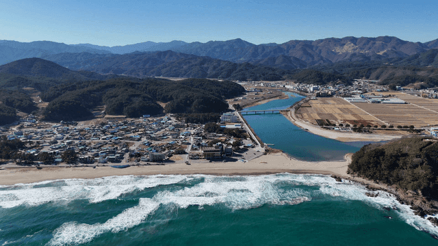 Coastal village with mountains and river