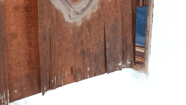 Aged wooden door with peeling paint