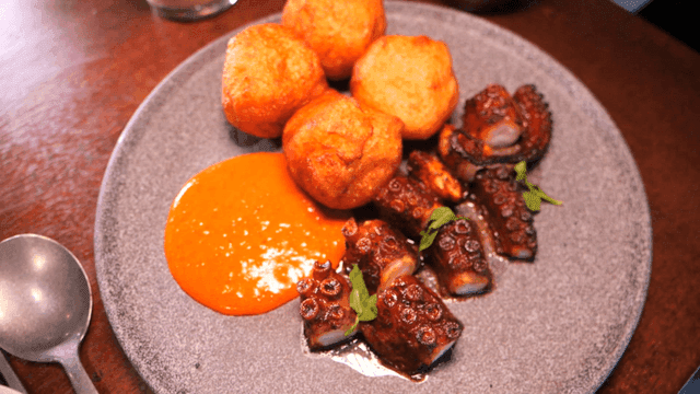 A plate of grilled octopus and fried balls