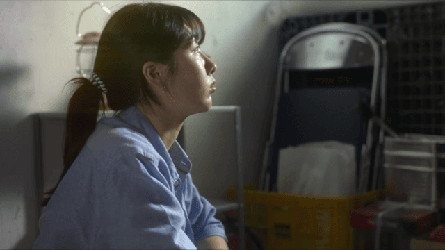 Woman sitting indoors in contemplation