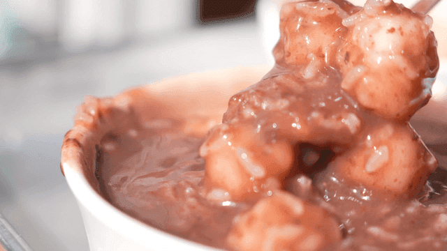 Spoon scooping out bowl of sweet red bean porridge