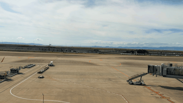 Empty airport runway under a clear sky