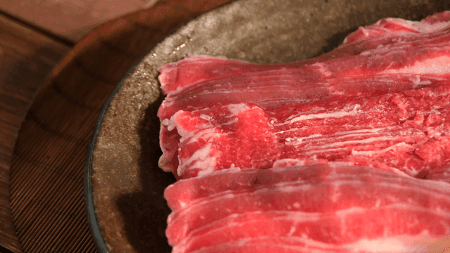 Fresh slices of raw beef on a plate