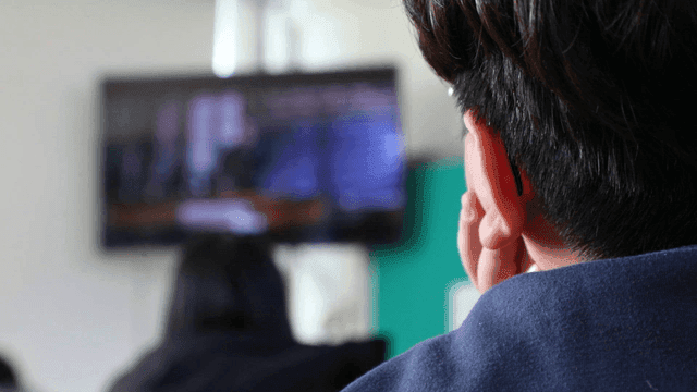 Back view of student watching video during class