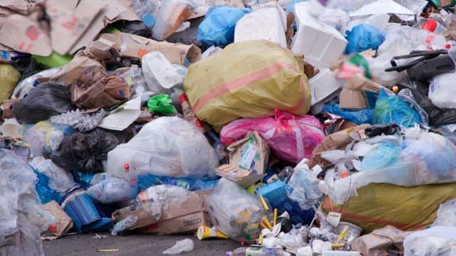 Pile of garbage including plastic, cardboard, and other waste materials