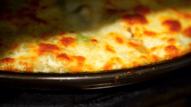 Cheese melting on a pizza in the oven