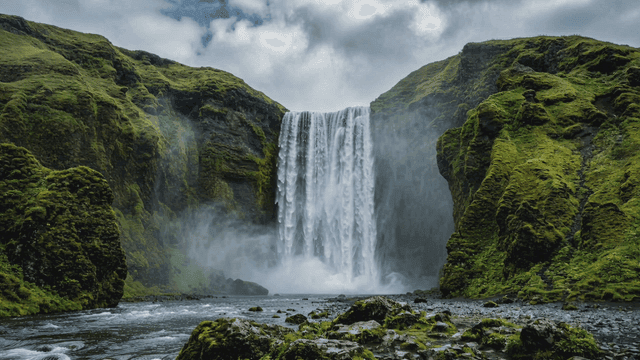 Majestic waterfall surrounded by lush vegetation.