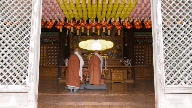 Monks praying inside a decorated temple