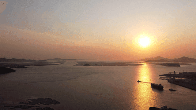 Sunset over a calm sea with distant islands