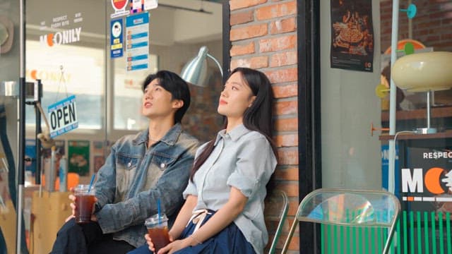 Couple enjoying iced coffee outdoors