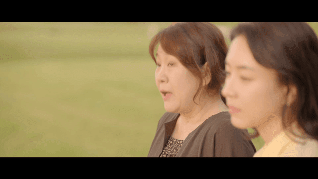Two women smiling and enjoying conversation outdoors