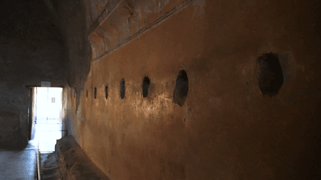 Dark ruins hallway with small hole