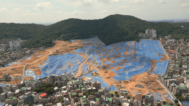Urban development site near forested hills