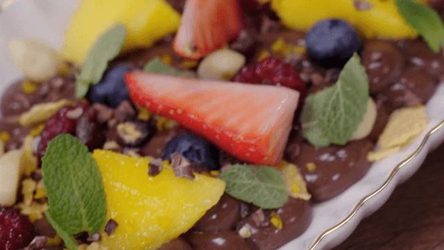 A colorful fruit-topped chocolate dessert