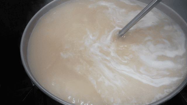 Pot of broth being stirred