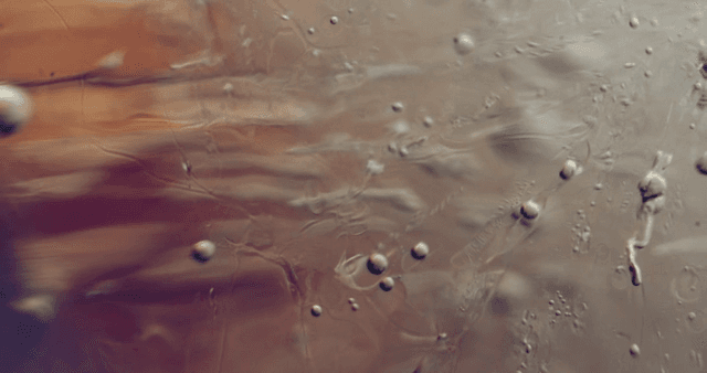 Abstract movement of water droplets in liquid