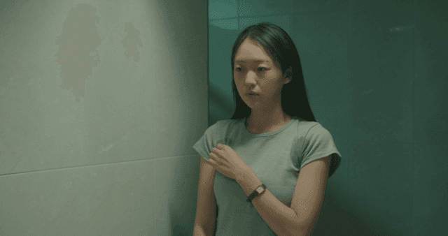 화장실에 거울을 보는 땀에 젖은 여성