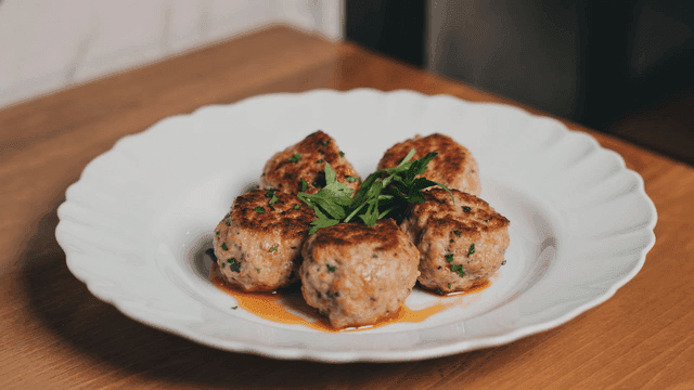 Plate of meatballs garnished with herbs