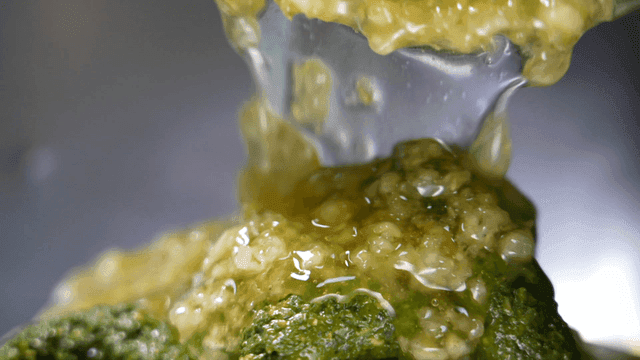 Sauce being poured over broccoli