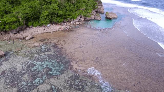 Scenic beach with people enjoying the water