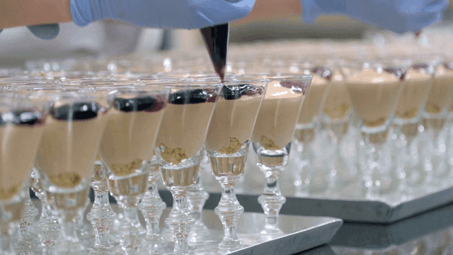 Desserts being prepared in glass cups
