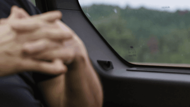 Man sitting in backseat of car