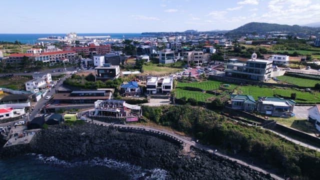 Panoramic view of a Coastal Village with Emerald Sea