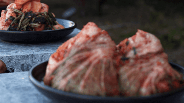 Various kimchi plates placed outdoors