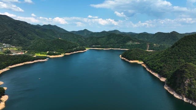 Serene Lake Surrounded by Lush Mountains