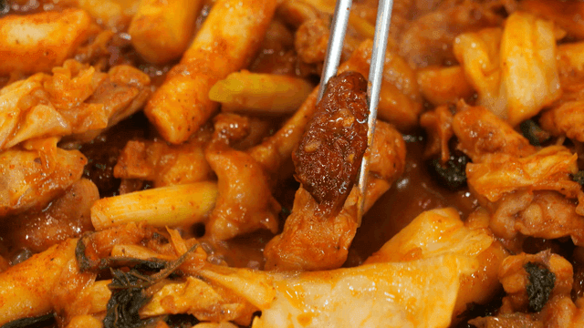 Chopsticks holding jujubes and dakgalbi