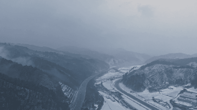 Snowy mountain landscape with winding roads