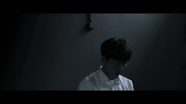 Young man in a dimly lit room