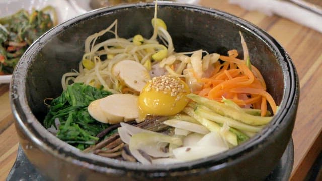 Bibimbap with fresh vegetables and egg yolk