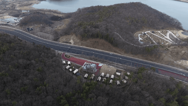 Aerial view of forest campsite with road